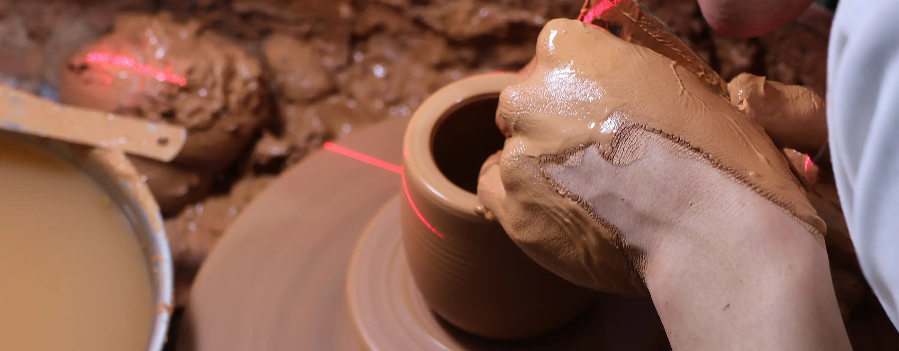 Process of wheel throwing Jianshui zitao clay, shaping the vessel by hand on the potter’s wheel