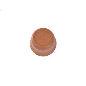 Bottom view of a Jianshui zitao red clay gaiwan with a hand-impressed seal and natural hand-finishing traces