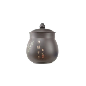Front view of a Jianshui zitao lidded office mug with hand-engraved bamboo design and calligraphy