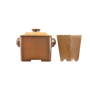 Back view of a handcrafted wood-fired Jianshui zitao square teapot and cup set with natural ash glaze texture