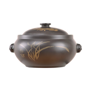 Handcrafted Jianshui zitao black steam pot featuring traditional hand-engraved decoration