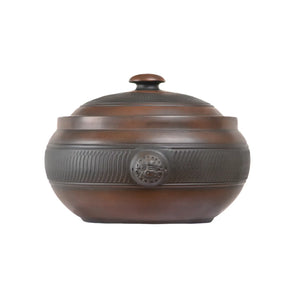 Front view of a handmade pottery steam pot with a chattering-carved texture band and fitted lid.