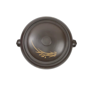 Top view: A Jianshui zitao black steamer with a matching lid, the body of which is decorated with hand-engraved orchid patterns