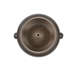 Top-down interior view of a Jianshui zitao black steam pot, showing the central steam vent