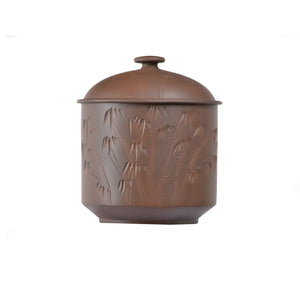 Jianhsui zitao tea canister(red clay) featuring an intricate hand-carved bamboo pattern, with a smooth matte glaze