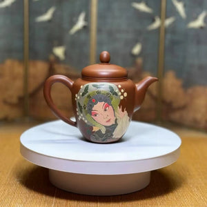Clay teapot featuring Peking Opera mask design in carved and inlaid technique