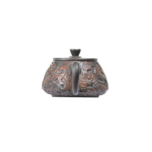 Back view of Jianshui Zitao Shipiao teapot No.32 showcasing detailed dragon and phoenix carving