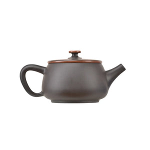 Side view of clay teapot featuring a minimalist smooth surface and gold waistline detail