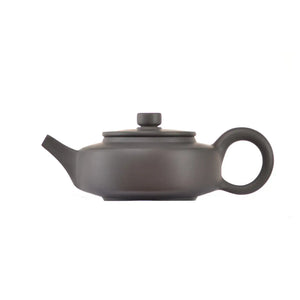 Side view of clay teapot No.18 with smooth uncarved surface and traditional form