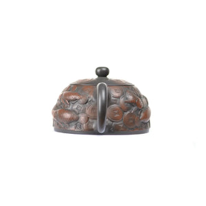 Back view of PorSva No.35 Shipiao coin and fish clay teapot featuring sculpted symbolic details