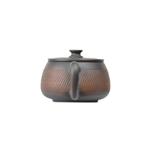 Back view of PorSva No.40 Hanwa chattering-knife texture clay teapot showing handcrafted surface
