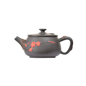 Handcrafted clay teapot with plum blossom design in root-inspired style, side view