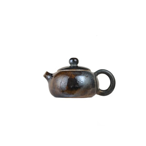 Left side view of PorSva No.60 wood-fired clay teapot with natural ash firing effects