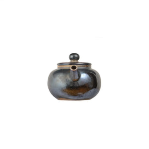 Front view of PorSva No.62 wood-fired clay teapot showing natural kiln firing marks