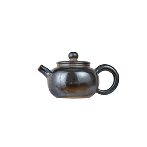 Left side view of PorSva No.62 wood-fired clay teapot with natural ash firing effects