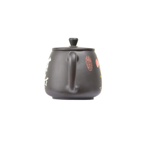 Back view of clay teapot No.25 featuring traditional yin carving and yang inlay decoration