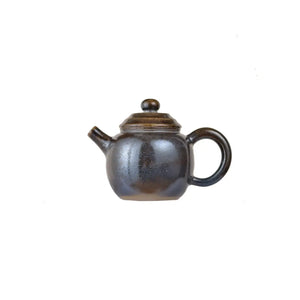 Left side view of PorSva No.65 wood-fired clay teapot with natural ash firing effects
