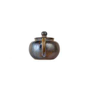 Back view of PorSva No.63 wood-fired clay teapot showing natural firing variations