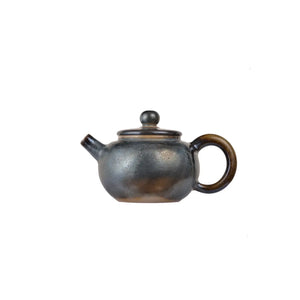 Left side view of PorSva No.63 wood-fired clay teapot with natural ash firing effects