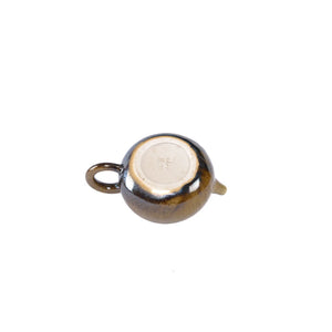 Bottom view of PorSva No.64 wood-fired Jianshui clay teapot displaying natural kiln marks