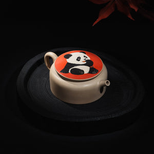 Angled view of Jianshui teapot with panda inlay lid