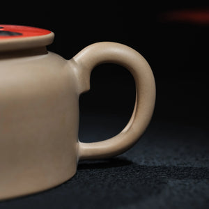 Side view showing the handle of Jianshui panda inlay teapot