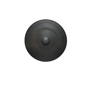 Top view of a handmade pottery tea cake storage box lid, featuring a raised center knob and a circular band of hand-carved jump-cut texture on a matte black surface.