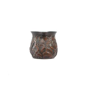 Front view of a Jianshui zitao fairness pitcher with fully carved lotus relief and unglazed matte finish