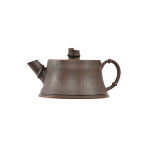 Jianshui zitao teapot with root-art bamboo-inspired vertical texture, side view.