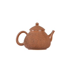 Jianshui zitao red clay pear-shaped teapot featuring dense needle-textured surface, side view
