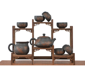 Handmade Shi Piao tea set with full line-carved lotus design, including teapot, fairness pitcher, and six multiple tea cups displayed on a wooden stand.