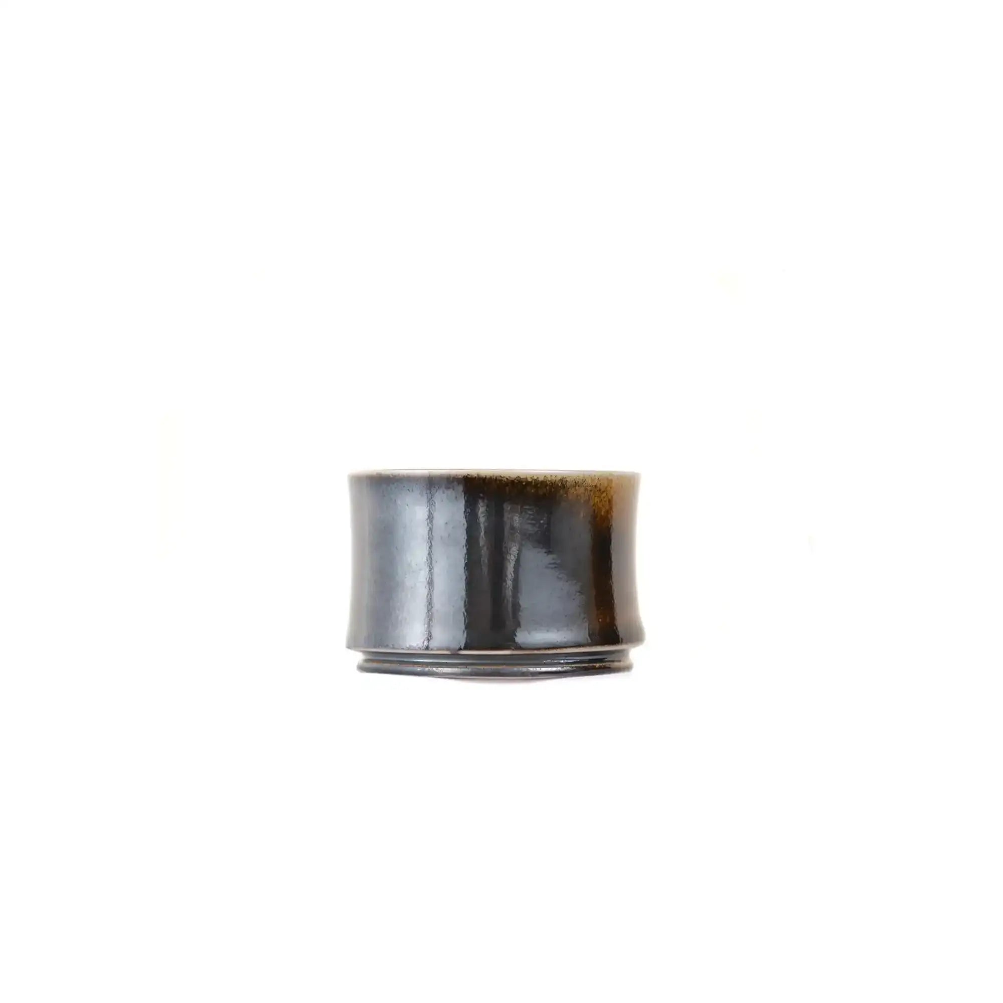 Jianshui zitao wood-fired cup showing distinct light and dark areas shaped by flame exposure, side view