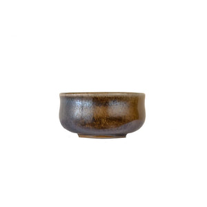 Jianshui zitao wood-fired cup showing natural flame marks and color transitions, side view.