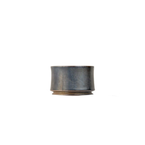 Jianshui zitao wood-fired cup showing gradual tonal shifts shaped by flame exposure, side view