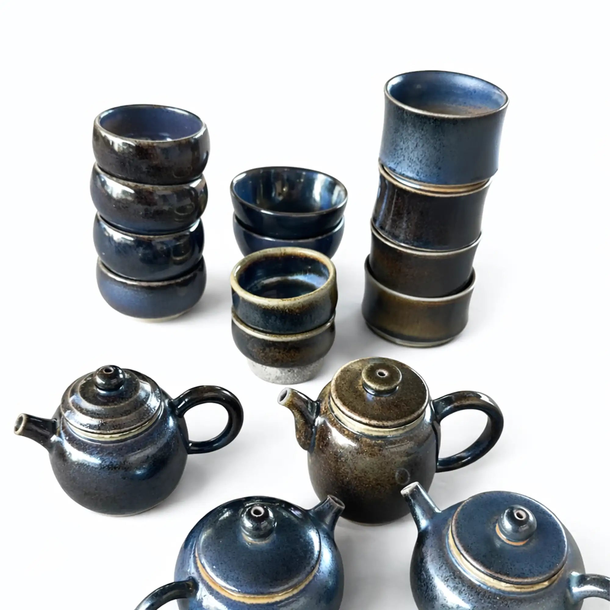 Wood-fired Jianshui zitao teapots and tea cups displaying natural kiln-fired surfaces
