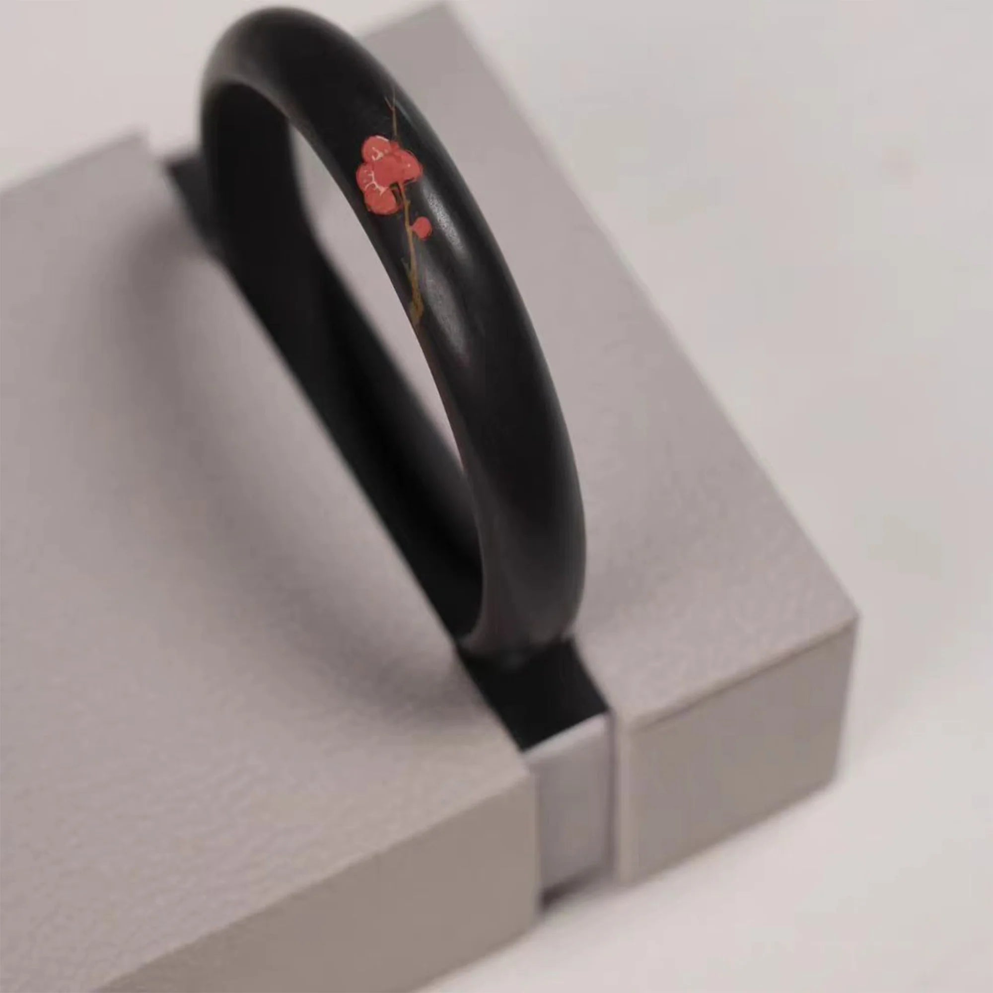 Jianshui zitao kiln-fired bracelet with hand-carved and clay-inlaid floral detail, displayed in a presentation box