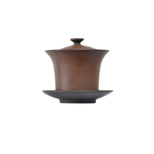 Handcrafted Jianshui zitao lidded teacup features a fluid design with Bodhi  detail, a flared rim, and comes with a matching saucer