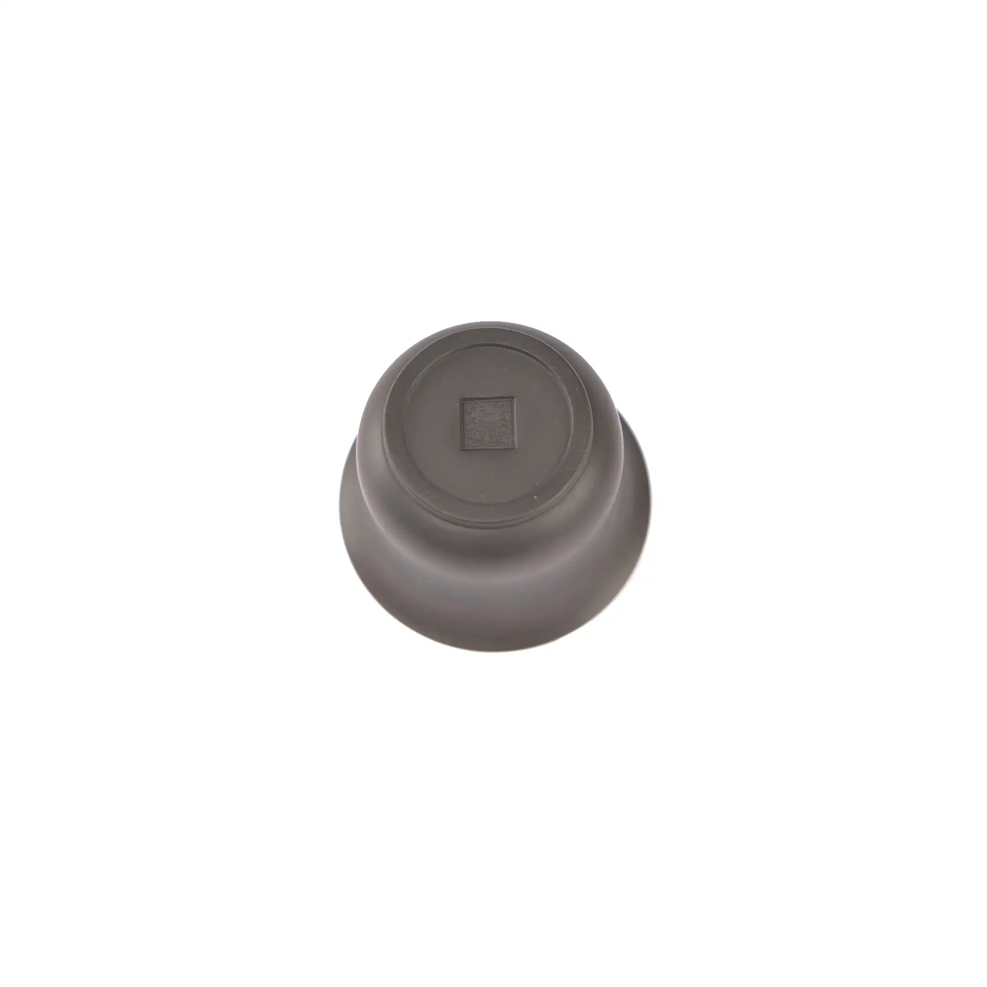 Bottom view of a Jianshui zitao gaiwan showing a softly impressed maker’s mark and hand-finished base
