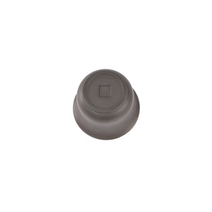 Bottom view of a Jianshui zitao gaiwan showing a softly impressed maker’s mark and hand-finished base