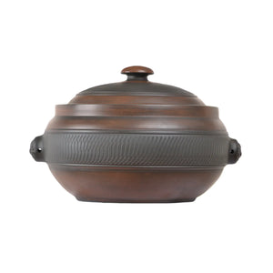 Handmade pottery steam pot with a chattering-carved texture and fitted lid.