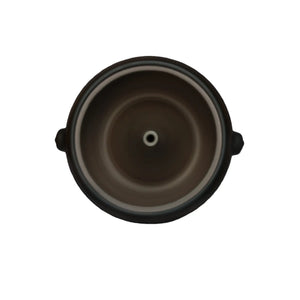 Top-down interior view of a handmade pottery steam pot showing the central steam vent hole.