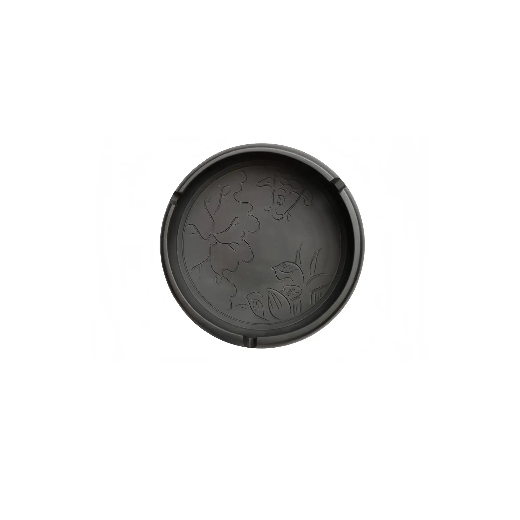 Top view of a Jianshui zitao ashtray with carved fish and lotus flower design