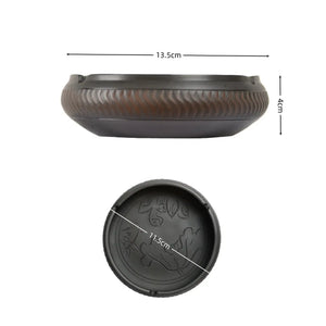 Dimensions of a handmade pottery ashtray with chattering-carved texture and lotus leaf and fish motif, showing 13.5 cm diameter and 4 cm height