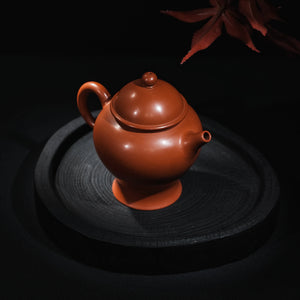 Angled view of handmade Jianshui red clay Ding teapot