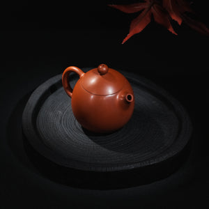 Jianshui red clay Dragon Egg teapot shown from an angled view