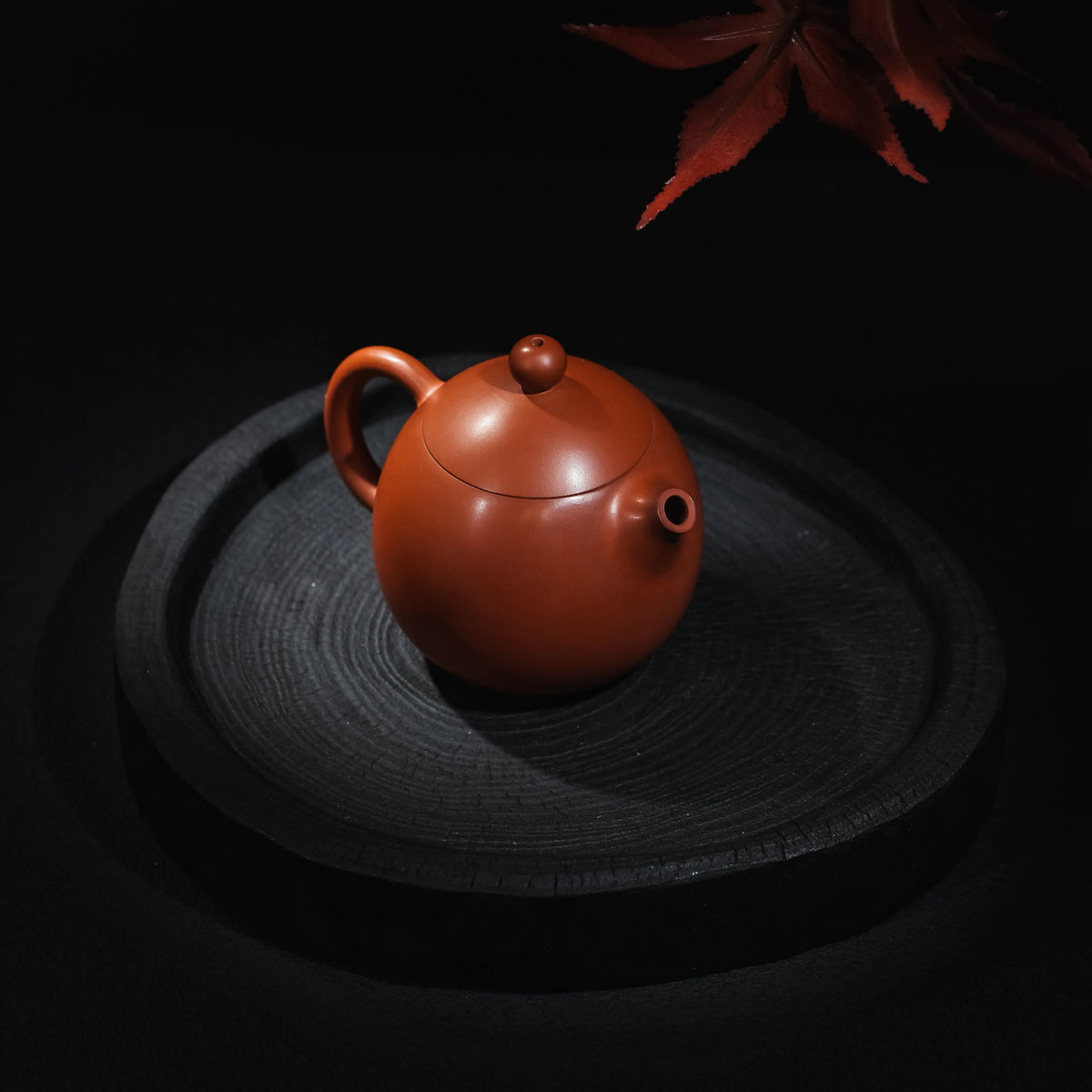 Jianshui red clay Dragon Egg teapot shown from an angled view