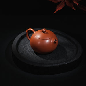 Angled view of handmade Jianshui red clay Xi Shi teapot