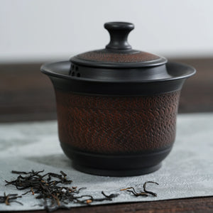 Front view of handmade Jianshui black chattering teapot