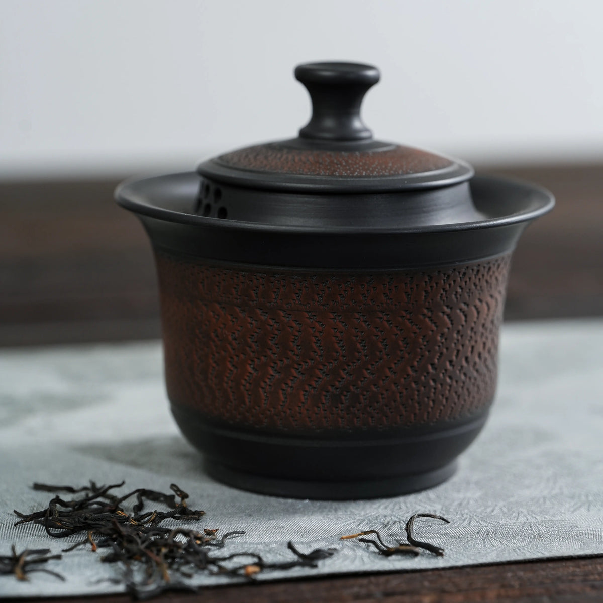 Front view of handmade Jianshui black chattering teapot