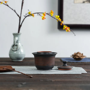 Side view of Jianshui black chattering handleless teapot
